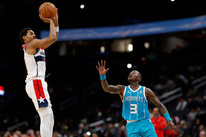 Jordan Poole (13) shoots the ball over Charlotte Hornets guard Terry Rozier